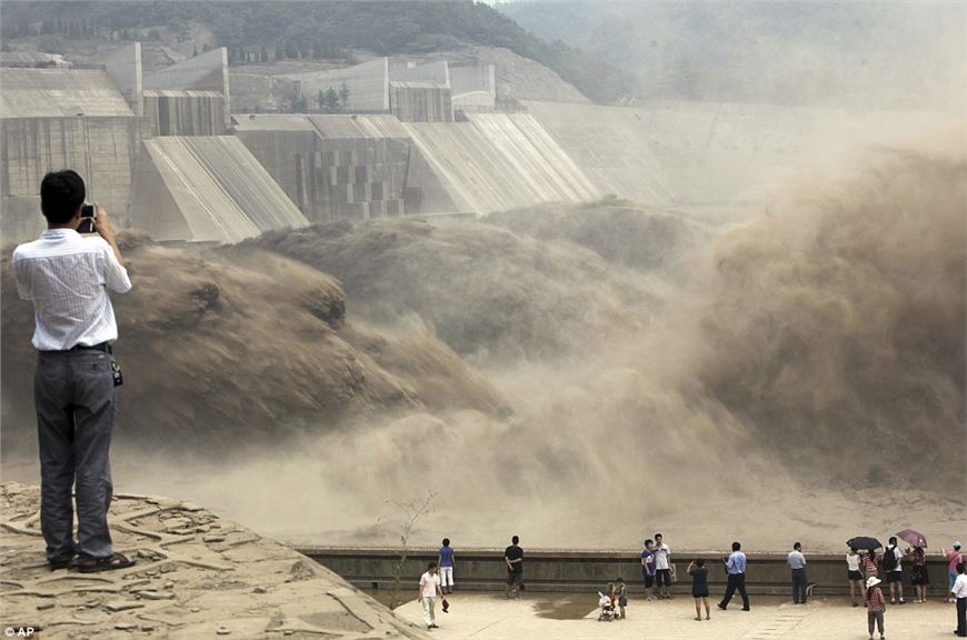China's giant man-made waterfall as floodgates are opened to send millions of tons of silt downstream.