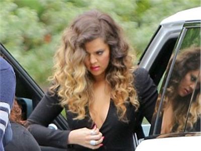 Khloe Kardashian takes the plunge in sexy wrap dress and suspender tights at hotel